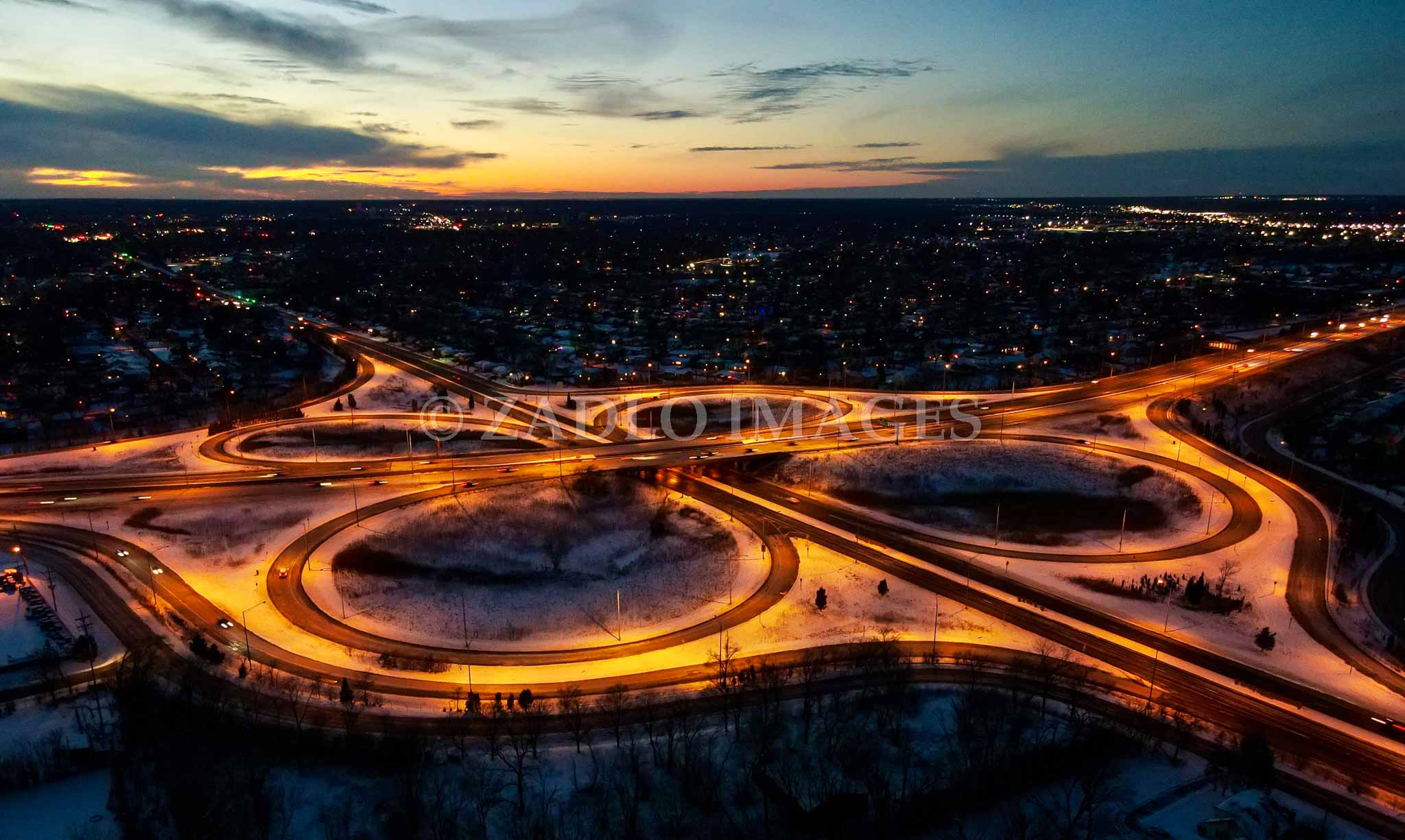 A long exposure photo of a highway with the sunset in the background.
