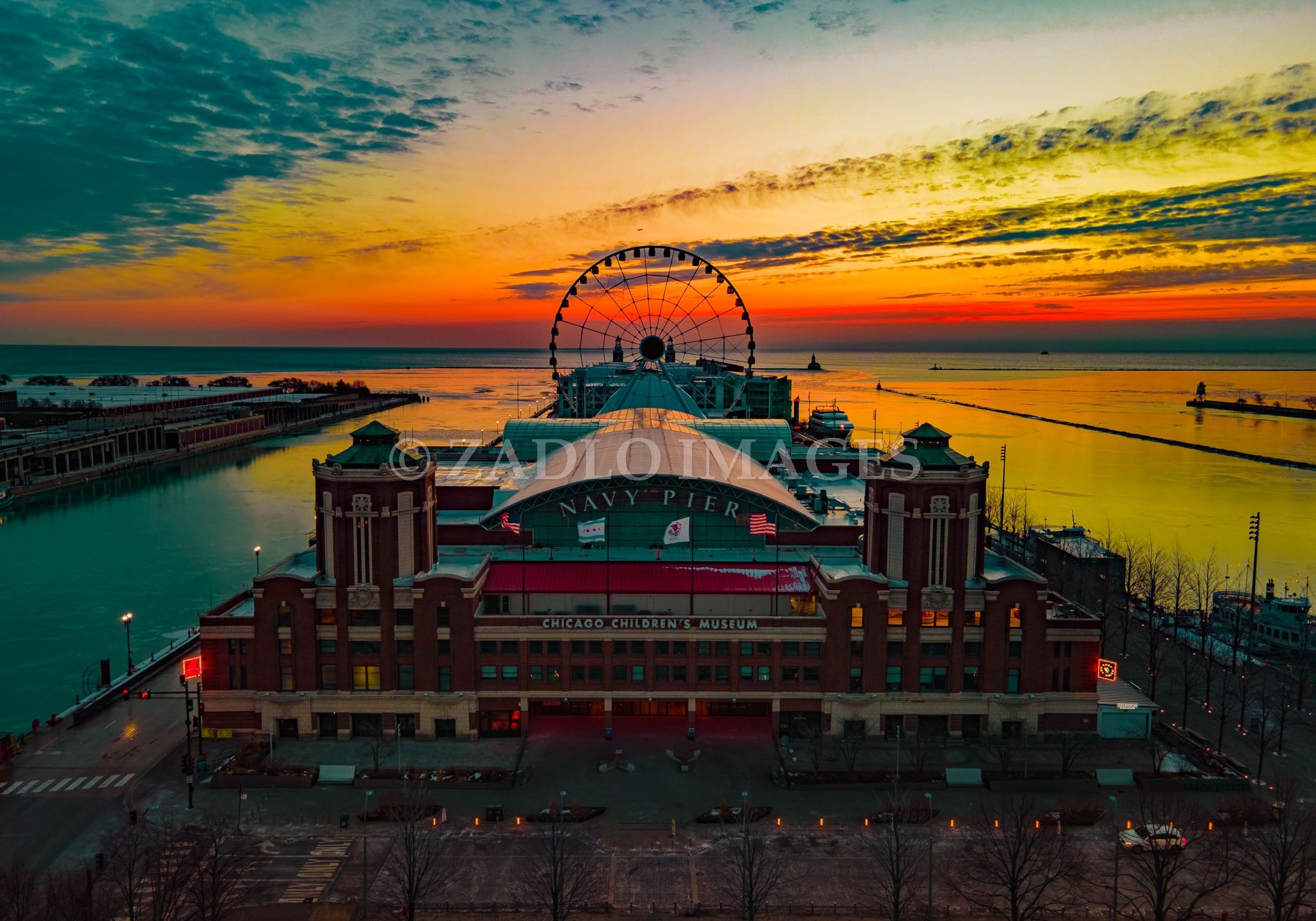 Drone photo of navy pier with a sunrise in the background.